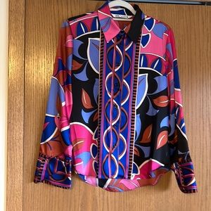 Multi color blouse, primarily pink.